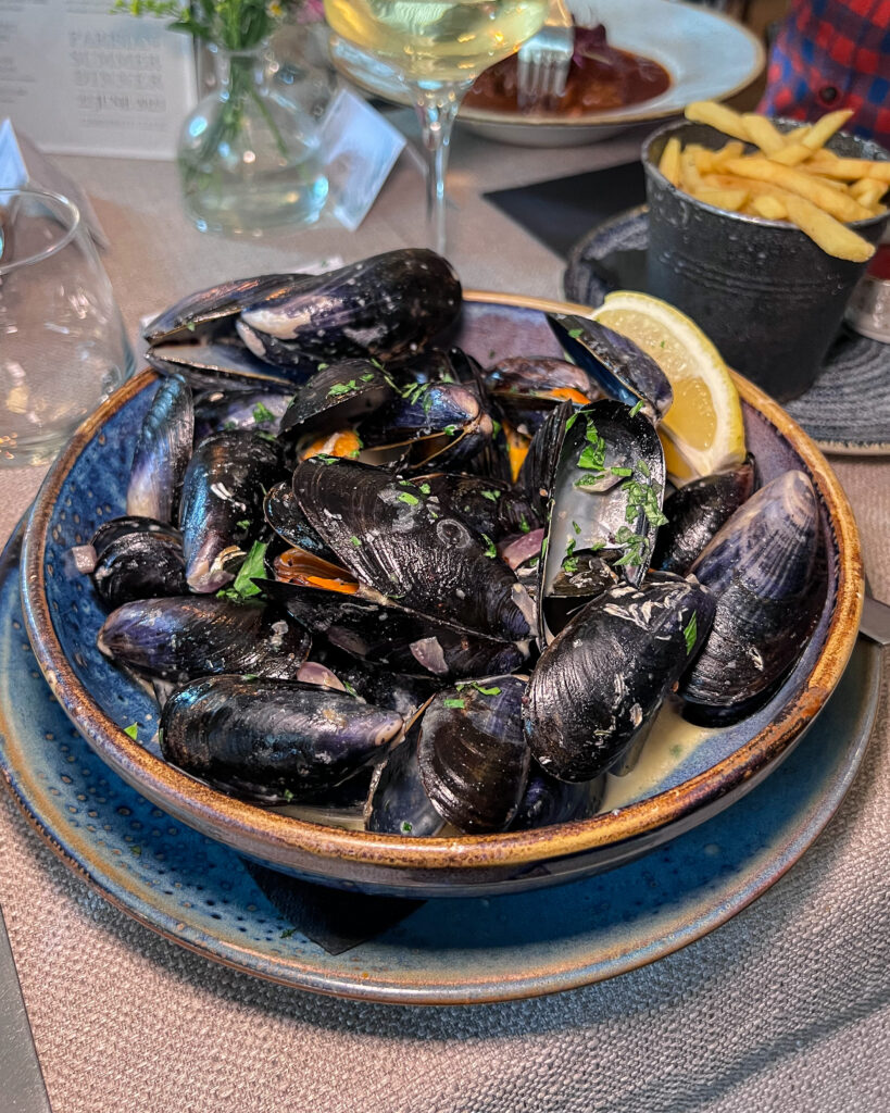 Large bowl of mussels with a wedge of lemon