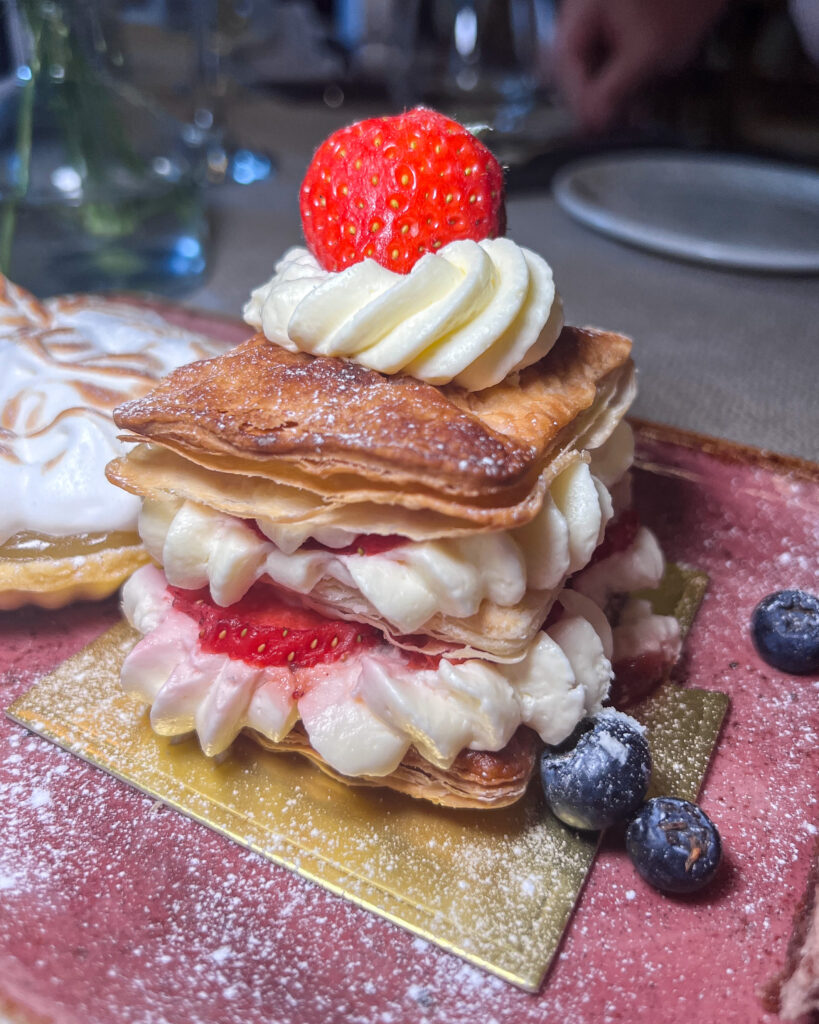 Layered pastry with whipped cream and bright red strawberries