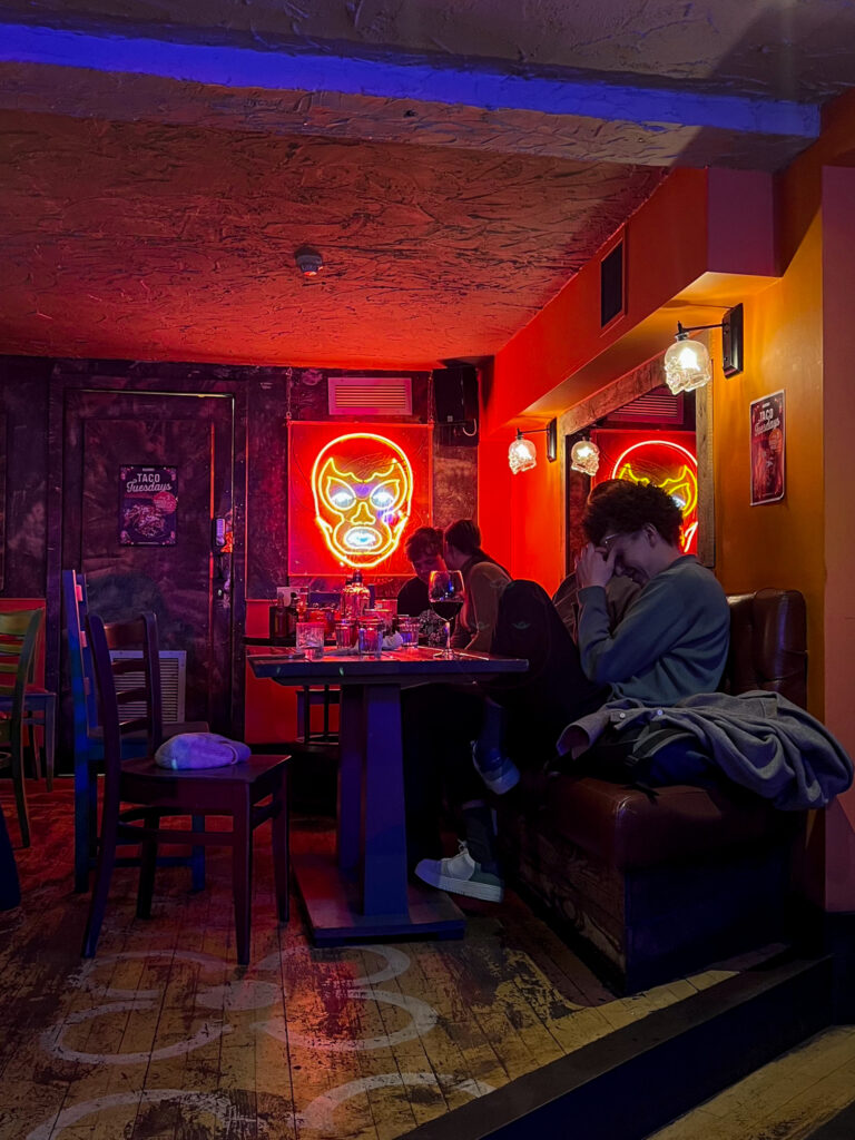 Interior of The Basement with neon face sign on the wall