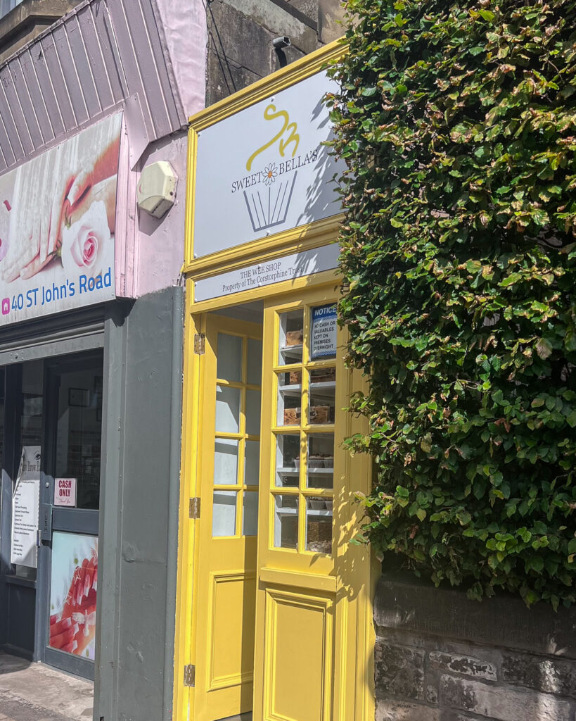 Small yellow door entrance to Sweet Bella's