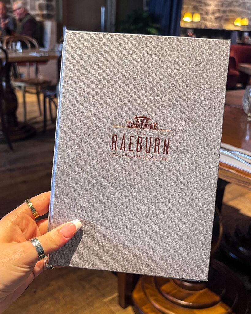 Grey menu front cover with The Raeburn text in foil