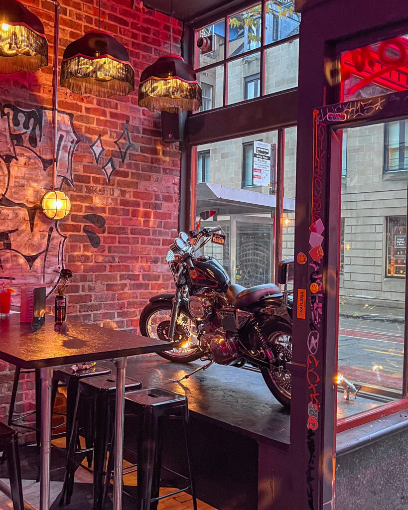 Interior shot of Dizzy Izzy's with a Harley Davidson motorbike in the window