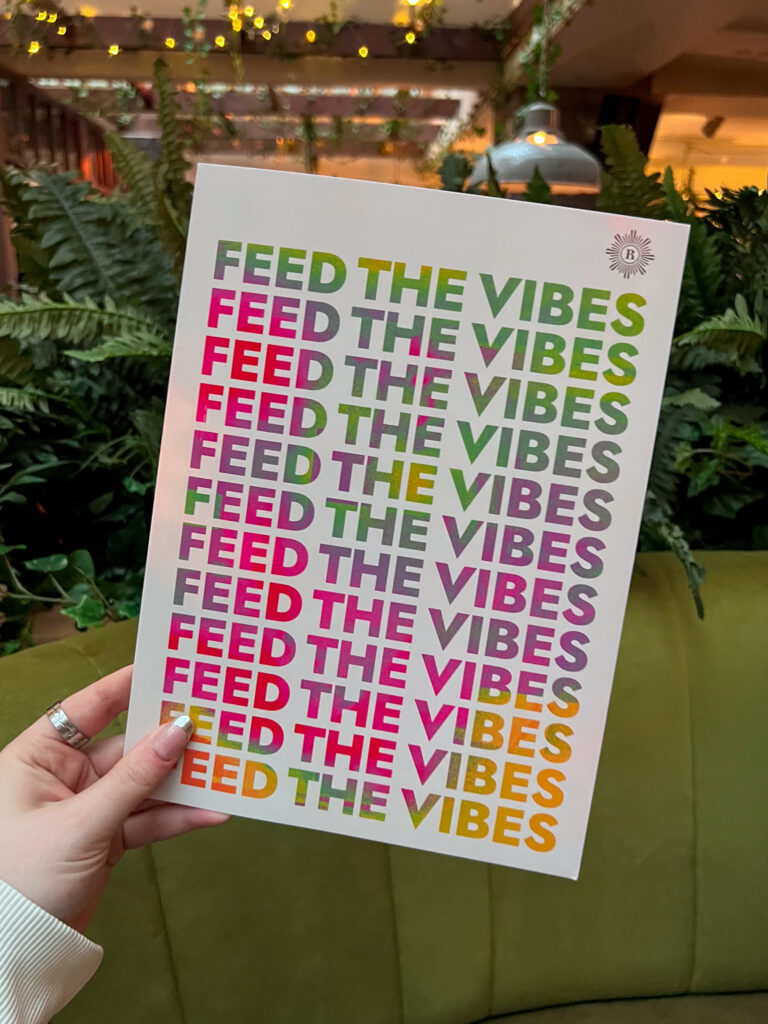 Revolution menu with feed the vibes written 11 times on the front