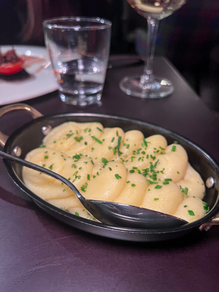 Creamy mashed potatoes garnished with chives from The Merchant Steakhouse