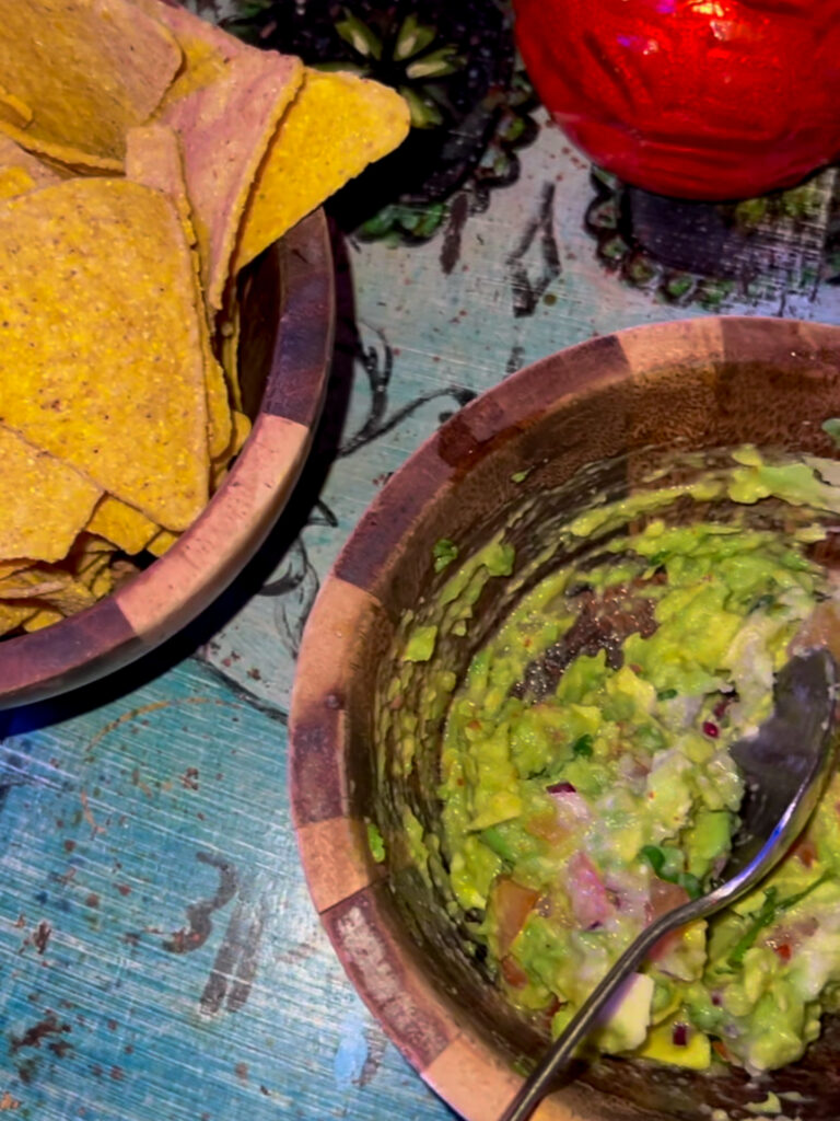 Bowls of tortilla chips and bright green guacamole from the Basement