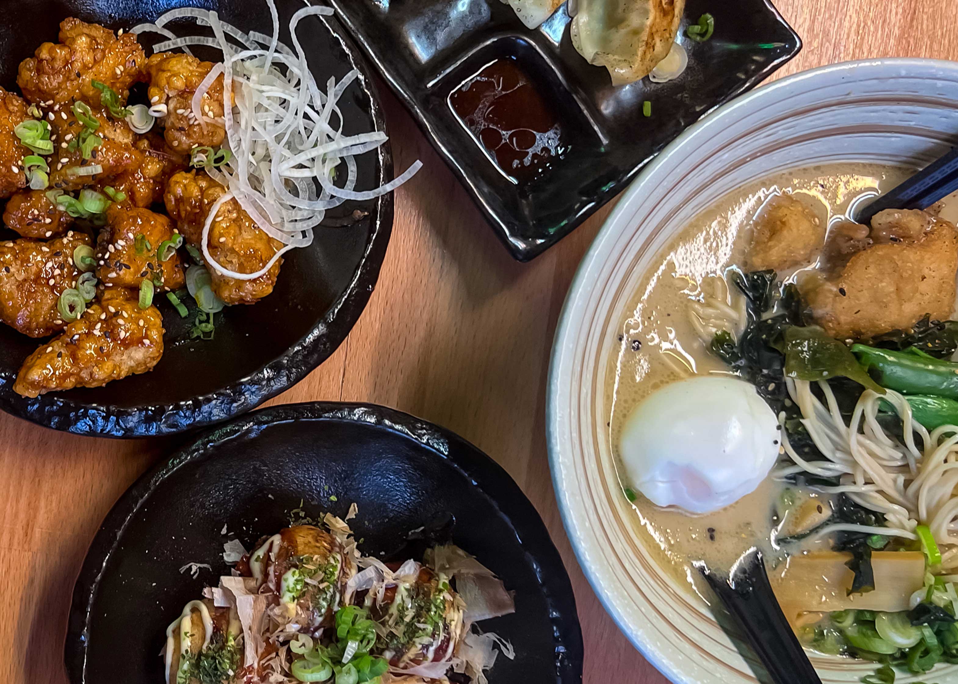 Birds eye view of ramen and small dishes from Ikigai