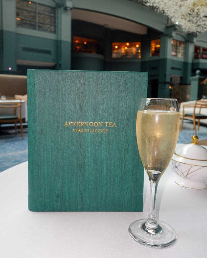 Menu and glass of champagne at afternoon tea at the Fairmont in St Andrews