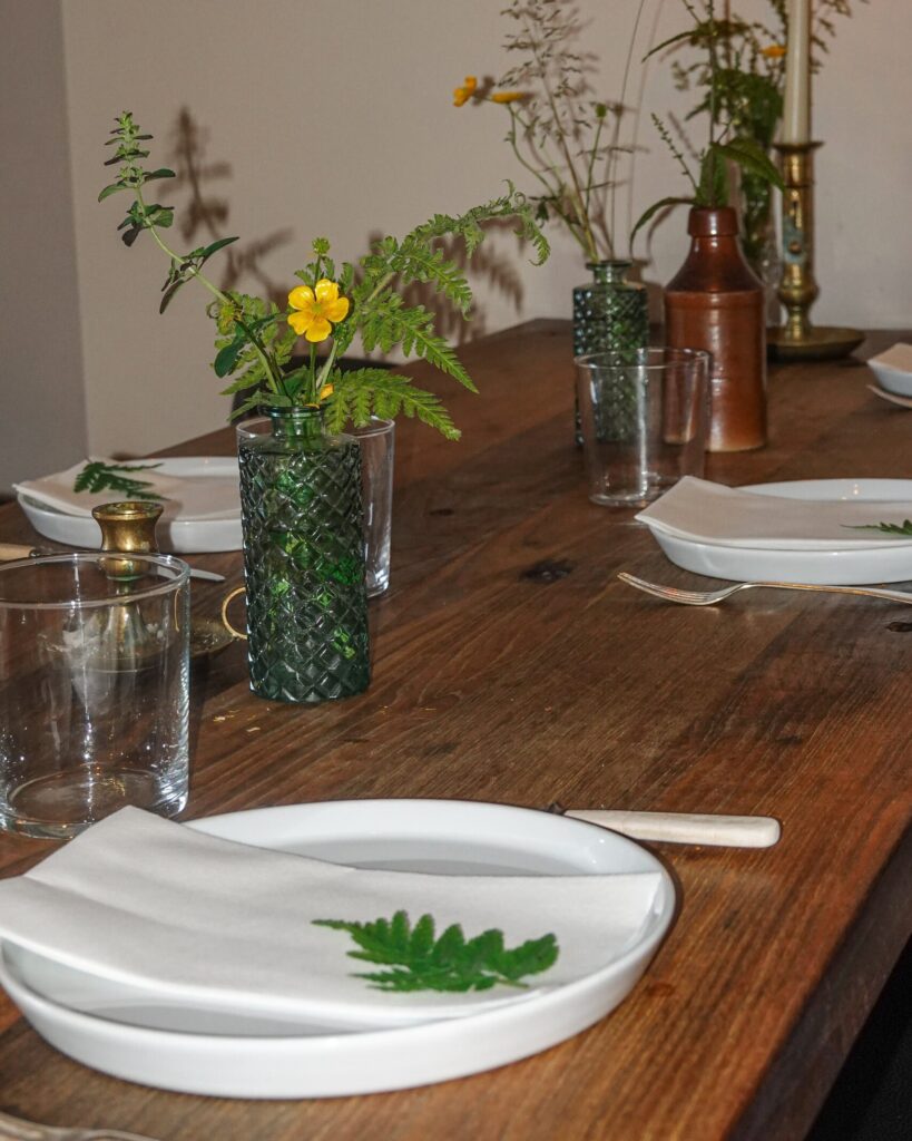 table setting with candles and flowers in the gardener's cottage